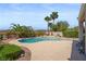 Backyard pool with tropical landscaping and mature palm trees at 2158 Shubert Ave, Henderson, NV 89052