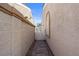A walkway through the side yard with desert landscaping and a privacy gate at 2158 Shubert Ave, Henderson, NV 89052