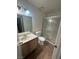 Bathroom features a single sink vanity with tile floors and shower with sliding glass door at 227 N Lamb Blvd # A, Las Vegas, NV 89110