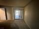 Bedroom with neutral walls, carpet and a sliding glass door to the outside at 227 N Lamb Blvd # A, Las Vegas, NV 89110
