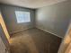 Bedroom has neutral walls and carpeting, with a window for natural light at 227 N Lamb Blvd # A, Las Vegas, NV 89110
