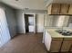 Kitchen area features tiled floors and includes a convenient laundry closet with washer/dryer at 227 N Lamb Blvd # A, Las Vegas, NV 89110