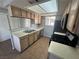 Functional kitchen featuring tiled floors, countertops, and stainless steel appliances at 227 N Lamb Blvd # A, Las Vegas, NV 89110
