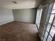 Bright living room with tile flooring and sliding glass door access to the exterior at 227 N Lamb Blvd # A, Las Vegas, NV 89110