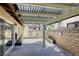 Covered backyard patio with brick wall and access to the home at 2349 Wooster Cir # A, Las Vegas, NV 89108