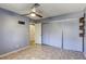 Bedroom features a ceiling fan, sliding closet doors, and tiled floor at 2349 Wooster Cir # A, Las Vegas, NV 89108