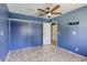 Bedroom with tiled floor, closet and ceiling fan at 2349 Wooster Cir # A, Las Vegas, NV 89108