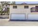 Building exterior featuring a two-car garage with white doors and neutral stucco siding at 2349 Wooster Cir # A, Las Vegas, NV 89108