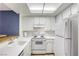 Bright, efficient kitchen with white appliances, ample counter space, and a skylight at 2349 Wooster Cir # A, Las Vegas, NV 89108