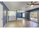 Bright living room with tile flooring, ceiling fan, and sliding glass doors to the patio at 2349 Wooster Cir # A, Las Vegas, NV 89108
