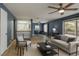 Inviting living room featuring neutral tones, a ceiling fan, and a sliding glass door to the backyard at 2349 Wooster Cir # A, Las Vegas, NV 89108