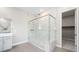 Elegant bathroom features a glass shower enclosure, modern fixtures, and a walk-in closet with ample storage space at 237 Paraggi Bay Dr, Henderson, NV 89011
