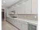 Modern kitchen with stainless steel appliances and long white countertop at 237 Paraggi Bay Dr, Henderson, NV 89011
