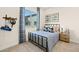 Cozy bedroom featuring natural light, a metal bed frame, neutral carpeting, and tasteful decorations for a relaxing ambiance at 243 Paraggi Bay Dr, Henderson, NV 89011