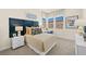 Bedroom featuring a cushioned headboard, natural light, and view to rock wall and sky at 243 Paraggi Bay Dr, Henderson, NV 89011