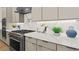Well-equipped kitchen with modern gas range, marble counters, and stylish backsplash at 243 Paraggi Bay Dr, Henderson, NV 89011