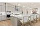 Modern kitchen with gray cabinets, a marble countertop island, stainless steel appliances, and pendant lighting at 243 Paraggi Bay Dr, Henderson, NV 89011