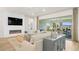 Open-concept living room with a modern fireplace, large sliding doors to a patio, and stylish contemporary furnishings at 243 Paraggi Bay Dr, Henderson, NV 89011