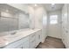 Elegant bathroom with double vanity, quartz countertop, and a glass-enclosed shower for a spa-like experience at 2637 Begonia Falls Ave # 87, North Las Vegas, NV 89081