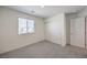 Neutral bedroom with a large window, carpeted floors, and a closet at 2637 Begonia Falls Ave # 87, North Las Vegas, NV 89081