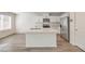 Contemporary kitchen boasts stainless appliances, a center island and gorgeous flooring at 2637 Begonia Falls Ave # 87, North Las Vegas, NV 89081