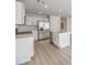 Spacious kitchen showcasing stainless steel appliances, white cabinets, and hardwood floors at 2637 Begonia Falls Ave # 87, North Las Vegas, NV 89081