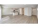 Bright, open-concept living space featuring hardwood floors, white walls, and an eat-in kitchen with a center island at 2637 Begonia Falls Ave # 87, North Las Vegas, NV 89081