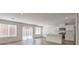 Open-concept living space featuring hardwood floors, white walls, and an eat-in kitchen with stainless appliances at 2637 Begonia Falls Ave # 87, North Las Vegas, NV 89081