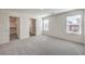 Spacious main bedroom features plush carpet, natural light from windows, and an attached walk-in closet and bath at 2637 Begonia Falls Ave # 87, North Las Vegas, NV 89081