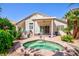 Inviting backyard with a refreshing spa, covered patio, and beautiful plants at 270 New River Cir, Henderson, NV 89052