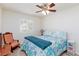 Bright bedroom featuring a ceiling fan, and a comfortable bed with floral patterned bedding at 270 New River Cir, Henderson, NV 89052