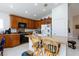 This eat-in kitchen features a breakfast bar, modern appliances, and granite countertops at 270 New River Cir, Henderson, NV 89052