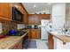 The modern kitchen features granite counters, white appliances, and wood cabinets at 270 New River Cir, Henderson, NV 89052