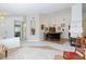 Bright living room with arched ceilings, a bar, and access to other rooms at 270 New River Cir, Henderson, NV 89052