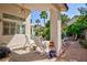 Relaxing outdoor patio featuring comfortable seating and a view of the landscaped yard at 270 New River Cir, Henderson, NV 89052