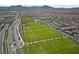 Expansive aerial shot showcasing the community's soccer field and lush landscaping at 2785 Donatello Manor Pl, Henderson, NV 89044