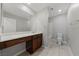 Bathroom featuring a spacious vanity with dark wood cabinets, a large mirror, and tile flooring at 2785 Donatello Manor Pl, Henderson, NV 89044