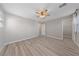 This bright bedroom features hardwood floors, a ceiling fan, closet, and entry to other rooms at 2785 Donatello Manor Pl, Henderson, NV 89044