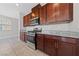 Kitchen featuring a gas range, granite countertops, and dark wood cabinets at 2785 Donatello Manor Pl, Henderson, NV 89044
