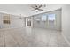 Spacious living room with large tile floors, modern ceiling fan and abundant natural light at 2785 Donatello Manor Pl, Henderson, NV 89044