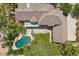 An aerial shot reveals the property's tile roof, pool, and spacious backyard with a covered patio at 3102 La Mirada Ave, Las Vegas, NV 89120