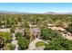 Aerial view shows the property's lush landscaping and circular driveway with mature trees at 3102 La Mirada Ave, Las Vegas, NV 89120