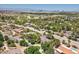Aerial view showcases the neighborhood's lush landscape and offers a glimpse of the city skyline at 3102 La Mirada Ave, Las Vegas, NV 89120