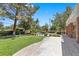 Backyard features a lush lawn, mature trees, and a pool creating a private oasis at 3102 La Mirada Ave, Las Vegas, NV 89120