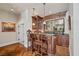 Cozy bar area featuring custom wood cabinets, a marble countertop, and bar seating at 3102 La Mirada Ave, Las Vegas, NV 89120