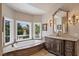 Luxurious bathroom with a large soaking tub, wood vanity, and bay window with neighborhood views at 3102 La Mirada Ave, Las Vegas, NV 89120
