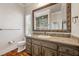 Elegant bathroom featuring a decorative mirror, granite counters, and wood floors at 3102 La Mirada Ave, Las Vegas, NV 89120