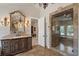 Luxurious bathroom featuring a vanity with double sinks, a glass-enclosed shower, and an oversized mirror at 3102 La Mirada Ave, Las Vegas, NV 89120