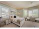 Comfortable bedroom with neutral decor, plush carpet, and large window allowing in lots of natural light at 3102 La Mirada Ave, Las Vegas, NV 89120