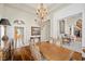 Elegant dining room with hardwood floors, large chandelier, and decorative moldings at 3102 La Mirada Ave, Las Vegas, NV 89120